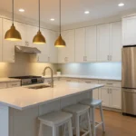 Modern kitchen demonstrating the best colour temperature for kitchen lighting with warm pendant lights over the island and cool white recessed ceiling lighting for balance