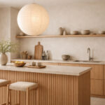 Serene scandi japandi kitchen lighting with oak slat island, beige stone worktop and rice paper lantern creating a soft zen atmosphere
